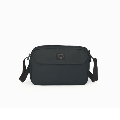 Front view of Osprey Aoede crossbody bag black showing minimalist design and magnetic flap pocket
