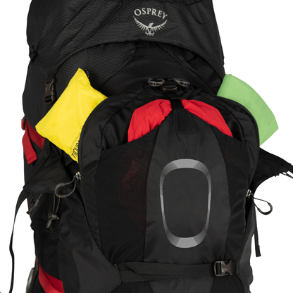 Osprey backpack with colorful items peeking out on a white background