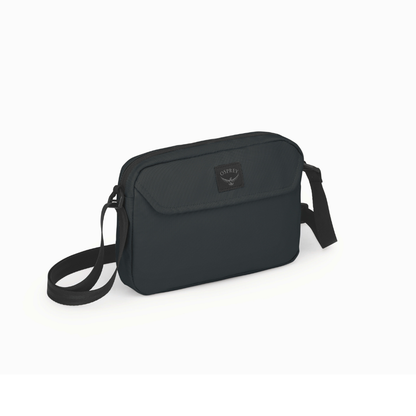 Side profile of Osprey Aoede crossbody bag black displaying sleek urban silhouette and adjustable strap