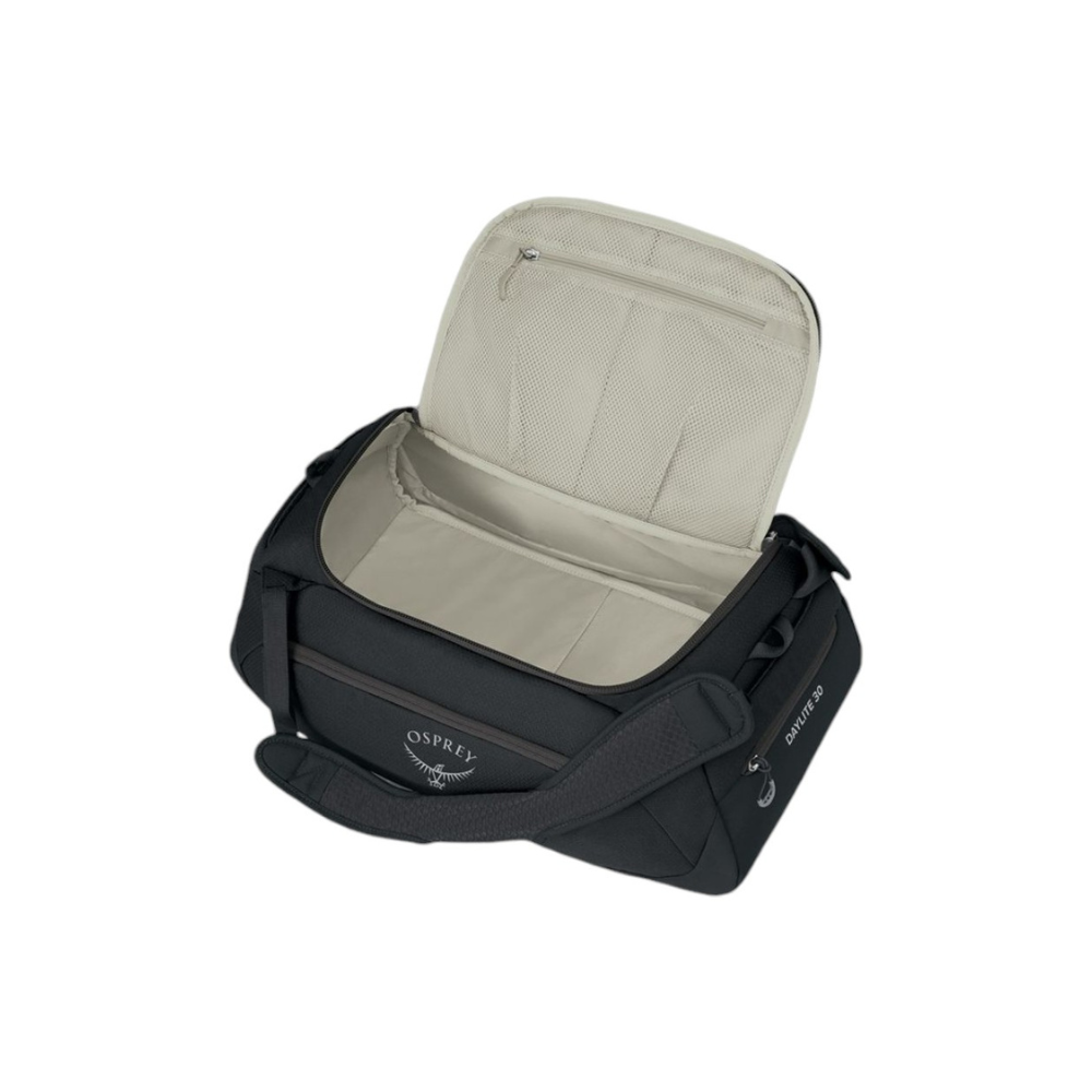 Side profile of Osprey Daylite Duffel 30 black displaying multi-pocket organization and grab handles
